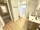 Bright bathroom displaying a modern single sink vanity and tub with shower at 417 S Oakland Ave, Indianapolis, IN 46201