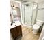 Bathroom featuring glass shower, wood vanity, and modern fixtures at 417 S Oakland Ave, Indianapolis, IN 46201