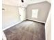 Cozy bedroom with carpet flooring, window, and neutral wall paint at 417 S Oakland Ave, Indianapolis, IN 46201