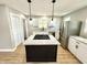 Modern kitchen featuring a large center island, granite countertops, and stainless steel appliances at 417 S Oakland Ave, Indianapolis, IN 46201