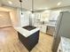 Well-lit kitchen featuring a large center island, stainless steel appliances, and granite counters at 417 S Oakland Ave, Indianapolis, IN 46201