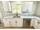 Modern kitchen showcasing white cabinets, granite countertops, and stainless steel dishwasher at 417 S Oakland Ave, Indianapolis, IN 46201