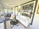 Bright sunroom with white sofa, dining area, and neutral tones with ample natural light at 417 S Oakland Ave, Indianapolis, IN 46201