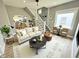 Inviting living room features a comfortable sofa, a stylish staircase, and an open view to the modern kitchen at 417 S Oakland Ave, Indianapolis, IN 46201