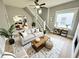 Bright living room featuring a comfortable sofa, open staircase, view into a modern kitchen and dining area at 417 S Oakland Ave, Indianapolis, IN 46201