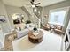 Cozy living room boasts a ceiling fan, staircase, and view of kitchen, exuding warmth and comfort at 417 S Oakland Ave, Indianapolis, IN 46201