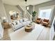 Elegant living room features a comfortable sofa, stylish chairs, and an open view to the kitchen at 417 S Oakland Ave, Indianapolis, IN 46201