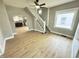Open-concept living room with hardwood floors, freshly painted walls, and staircase at 417 S Oakland Ave, Indianapolis, IN 46201