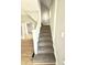 Carpeted staircase with wooden railing, connecting to hardwood floor landing at 417 S Oakland Ave, Indianapolis, IN 46201