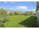 Lush backyard featuring lawn and trees with neighboring houses at 4324 Homestead Dr, Whitestown, IN 46075