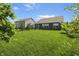 Lush backyard featuring lawn, trees, and view of neighboring houses at 4324 Homestead Dr, Whitestown, IN 46075