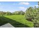 Large backyard with lush lawn, trees, and partial fence at 4324 Homestead Dr, Whitestown, IN 46075
