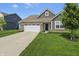 Beautiful single-Gathering home with a two-car garage, brick details, and lush green lawn at 4324 Homestead Dr, Whitestown, IN 46075