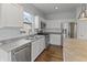 Kitchen area features stainless appliances, an island, and crisp white cabinetry at 4324 Homestead Dr, Whitestown, IN 46075