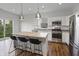 Kitchen view featuring an island with seating, stainless steel appliances, and natural light at 4324 Homestead Dr, Whitestown, IN 46075