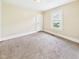 Cozy bedroom features soft carpet and a bright window for natural lighting at 510 E 23Rd St, Anderson, IN 46016