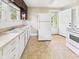 Bright kitchen features ample counter space, white appliances, and tile flooring at 510 E 23Rd St, Anderson, IN 46016