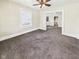 Neutral toned living room features plush carpet and natural light through a large window at 510 E 23Rd St, Anderson, IN 46016