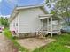 Rear exterior with a small porch and yard at 510 E 23Rd St, Anderson, IN 46016