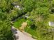 Aerial view of a property nestled among mature trees and greenery, showcasing its serene location at 5648 Rolling Ridge Rd, Indianapolis, IN 46220