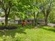 Spacious backyard with a swing set and mature trees offering ample shade at 5648 Rolling Ridge Rd, Indianapolis, IN 46220
