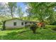 A beautiful backyard featuring a swing set, a well-manicured lawn, and mature trees offering ample shade at 5648 Rolling Ridge Rd, Indianapolis, IN 46220