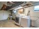 Spacious basement laundry area with washer, dryer, sink, and storage at 5648 Rolling Ridge Rd, Indianapolis, IN 46220