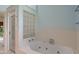 Bright bathroom with a glass-block window over the bathtub and a glass shower at 5648 Rolling Ridge Rd, Indianapolis, IN 46220