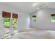 Spacious bedroom with vaulted ceilings, ceiling fan, double doors to backyard, and windows with privacy shades at 5648 Rolling Ridge Rd, Indianapolis, IN 46220