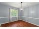 Cozy dining room with hardwood floors, soft gray walls, and a stylish light fixture, perfect for Gathering meals at 5648 Rolling Ridge Rd, Indianapolis, IN 46220