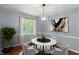 Bright dining room with modern light fixture, light gray walls, and marble dining table at 5648 Rolling Ridge Rd, Indianapolis, IN 46220
