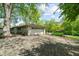 A paved driveway leading to a two-car garage, surrounded by mature trees and landscaping at 5648 Rolling Ridge Rd, Indianapolis, IN 46220