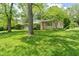 A beautifully landscaped ranch style home with a well-manicured lawn and mature trees offering plenty of shade at 5648 Rolling Ridge Rd, Indianapolis, IN 46220