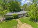Aerial view of a house with mature trees, stone details, and a well-maintained lawn at 5648 Rolling Ridge Rd, Indianapolis, IN 46220