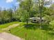 Well-manicured front lawn, mature trees, and a stone path leading to the home's entrance at 5648 Rolling Ridge Rd, Indianapolis, IN 46220