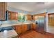 Traditional kitchen with wood cabinets, stainless steel appliances, and window overlooking backyard at 5648 Rolling Ridge Rd, Indianapolis, IN 46220
