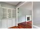 Bright living room with hardwood floors, a built-in display cabinet, and a cozy fireplace at 5648 Rolling Ridge Rd, Indianapolis, IN 46220