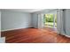 Spacious living room with hardwood floors, large windows, and neutral walls awaiting your personal touch at 5648 Rolling Ridge Rd, Indianapolis, IN 46220