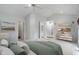 Neutral bedroom with vaulted ceiling, ceiling fan, staging, and doors to bathroom and hallway at 5648 Rolling Ridge Rd, Indianapolis, IN 46220