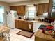 A functional kitchen with essential appliances, wooden cabinets, and a small dining area at 569 Meadow Dr, Danville, IN 46122