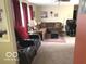 Spacious living room featuring plush carpet, recessed lighting, and comfortable seating, creating a welcoming atmosphere at 569 Meadow Dr, Danville, IN 46122