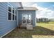 Back patio featuring sliding glass door and a small deck, with a view of the yard and adjacent homes at 5770 Flagler Ln, Brownsburg, IN 46112