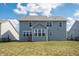 View of backyard featuring a well-maintained lawn and a blue two-story house at 5770 Flagler Ln, Brownsburg, IN 46112