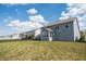 Wide backyard view showcasing a home's blue exterior and lush, green lawn at 5770 Flagler Ln, Brownsburg, IN 46112
