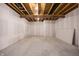 Unfinished basement area with painted drywall walls and open ceiling beams ready for customization at 5770 Flagler Ln, Brownsburg, IN 46112
