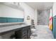 Well-lit bathroom featuring granite countertops, modern fixtures, and stylish blue wainscoting at 5770 Flagler Ln, Brownsburg, IN 46112