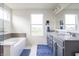 Bright bathroom showcasing a double vanity, tub, and stylish blue accent rug at 5770 Flagler Ln, Brownsburg, IN 46112