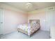 Bright bedroom with a floral patterned bed and natural light, creating a cheerful and inviting space at 5770 Flagler Ln, Brownsburg, IN 46112