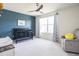 Charming bedroom with a crib, blue accent wall, and decorative curtains at 5770 Flagler Ln, Brownsburg, IN 46112