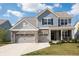 Charming two-story home with blue siding, brick accents, and a spacious two-car garage at 5770 Flagler Ln, Brownsburg, IN 46112